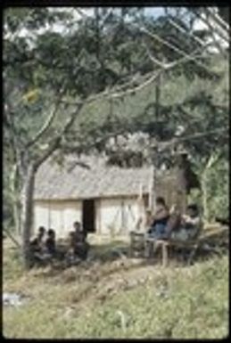 Susan Pflanz-Cook and others sitting on bench near Cooks' house