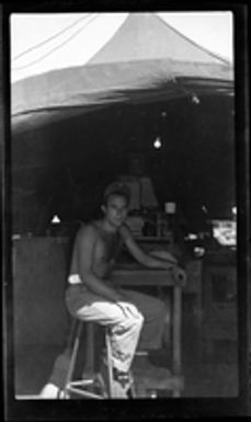 [Elmer A. Ball sitting at worktable]