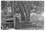 Woman at tap, troughs for washing