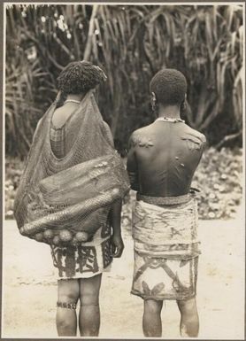 Ambasi villages, North Coast [ two woman with their backs to the camera, one with scars on her back and the other carrying a billum,] Frank Hurley