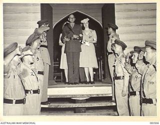 HERBERTON, QLD. 1944-11-17. LIEUTENANT C.E. BALCOMBE-BEGG, 2/1 INFANTRY BATTALION, (5), WITH HIS BRIDE (NEE MISS RUTH LEHMKUHL), (6), LEAVING THE ROMAN CATHOLIC CHURCH. TROOPS OF THE UNIT FORM A ..