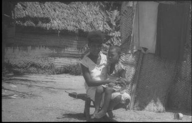 Woman sitting on a coconut scraping stool : Carteret Islands, Papua New Guinea, 1960 / Terence and Margaret Spencer