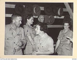 LAE, NEW GUINEA. 1945-05-11. LIEUTENANT GENERAL F.H. BERRYMAN, CHIEF OF THE GENERAL STAFF (1), TALKING WITH LIEUTENANT COLONEL M.J. SPENCER, ASSISTANT CONTROLLER AUSTRALIAN WOMEN'S ARMY SERVICE ..