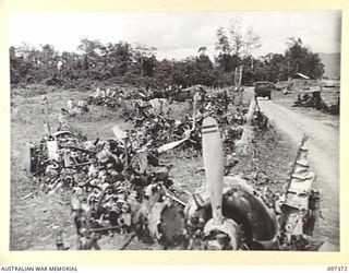 BOUGAINVILLE. 1945-09-28. ENGINES FROM WRECKED JAPANESE AIRCRAFT LINE THE ROAD TO KAHILI AIRSTRIP. THE JAPANESE ARMY AND NAVY HEADQUARTERS ARE LOCATED IN THIS AREA