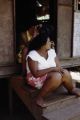 French Polynesia, women sitting on steps of home on Tahiti Island