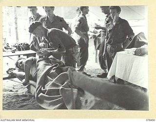 BOUGAINVILLE ISLAND. 1945-01-16. QX56044 PRIVATE J. PARDON, 47TH INFANTRY BATTALION (1), WHO WAS WOUNDED BY AN ENEMY MORTAR SHELL, AT THE ADVANCED DRESSING STATION OF THE 7TH FIELD AMBULANCE. ..