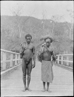 Two men crossing a wooden bridge, Papua, ca. 1923 / Sarah Chinnery