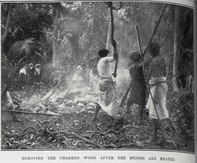 Removing the charred wood after the stones are heated