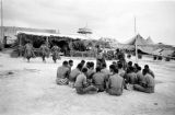 Malaysia, Fiji military men watching meke performance at camp