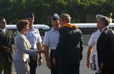 US President George W. Bush and his wife Laura, arrive at Hickam Air Force Base (AFB), Hawaii (HI) and are immediately greeted by the Commander of the 15th Airlift Wing (AW), Hickam Air Force Base (AFB), US Air Force (USAF) Colonel (COL) Raymond G. Torres, left and USAF General (GEN) William J. Begert, Commander of the Pacific Air Forces (PAF) and Air Component Commander for the US Pacific Command (USPACOM), at Hickam AFB