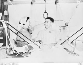 BAULKHAM HILLS, NSW. 1944-03-23. NFX149019 PRIVATE J. BATTEN, AN AUSTRALIAN ARMY MEDICAL WOMEN'S SERVICE MEMBER OF THE STAFF OF THE 103RD GENERAL HOSPITAL STRAIGHTENING THE PILLOWS FOR NX43968 ..