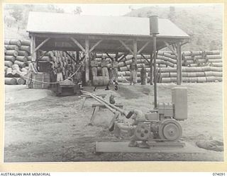 PORT MORESBY, NEW GUINEA. 1944-06-27. THE 44 GALLON DRUM WASHING MACHINE OF THE 1ST BULK PETROLEUM STORAGE COMPANY. THE MACHINE IS OPERATED BY A RONALDSON AND TIPPETT MOTOR, WHICH IS MOUNTED ON A ..