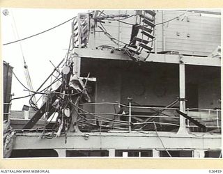 OFF PORT MORESBY, PAPUA. 1942-08-30. DAMAGED UPPERWORKS ON THE STARBOARD SIDE OF M.V. MALAITA, TORPEDOED BY AN ENEMY SUBMARINE OFF PORT MORESBY. THE MALAITA WAS TOWED INTO PORT THE DAY AFTER THE ..