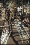 House-building: Kwiop men weave wall panels of plant material for the Cooks' house