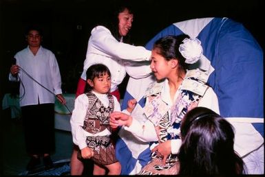 Gwenda Naepi, receiving a lei made of notes, at Niuean ear-piercing ceremony, Auckland