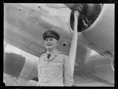 Flying Officer, J D Campbell, ex RNZAF near an aircraft, Rarotonga, Cook Islands