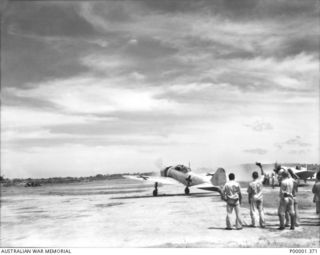 Two of the three surrendered Japanese A6M5 Model 52 Zero aircraft of the Imperial Japanese Navy on the move.The aircraft were painted in the surrender colours of white with green crosses.(See also ..