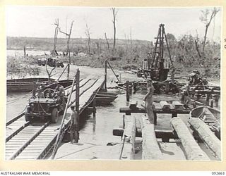 MINGA CREEK, WEWAK AREA, NEW GUINEA. 1945-05-30. GENERAL VIEW OF BRIDGE BEING CONSTRUCTED BY 2/8 FIELD COMPANY ROYAL AUSTRALIAN ENGINEERS, SHOWING FRESHLY DRIVEN PILES AND PREPARATIONS IN PROGRESS ..