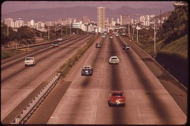 ON H-1 (OR LUNALILO) FREEWAY LOOKING WEST TOWARD DOWNTOWN HONOLULU. TALLEST BUILDING IS NEW "TOWN HOUSE."