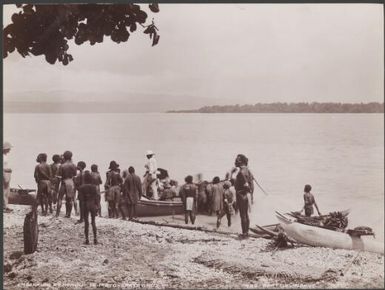 Missionaries and villagers gathered around boat on a Te Motu beach, Santa Cruz Islands, 1906 / J.W. Beattie