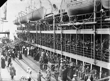 Aldersley, David James 1862-1928 : HM Transport Tahiti with World War troops, alongside a wharf