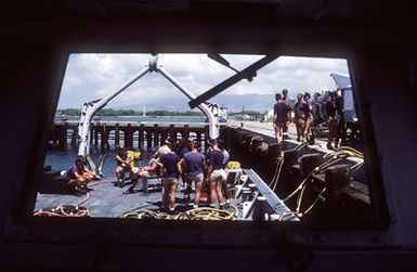 Members of Mobile Diving Salvage Unit 1 prepare to dive at the USS ARIZONA Memorial site. Salvage Unit 1 is participating in the joint Navy/Park Service project SeaMark, a surveying and charting effort to assess submerged cultural resources in the Pacific