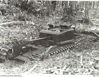 MADANG, NEW GUINEA. 1944-10. A CHURCHILL VII TANK BOGGED DOWN DURING TESTS CONDUCTED AT HQ 4 ARMOURED BRIGADE