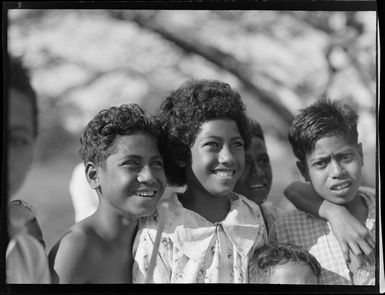 A close-up portrait of local Tongan children with big smiles, Tonga
