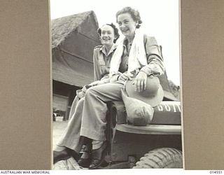 1943-04-01. AUSTRALIAN NURSES IN NEW GUINEA. SISTER E. SPILLER OF GEELONG, VICTORIA AND SISTER J.A. LINDSAY OF FREMANTLE, WESTERN AUSTRALIA, CLIMB ON A JEEP TO GO FOR A SWIM. (NEGATIVE BY N. BROWN)