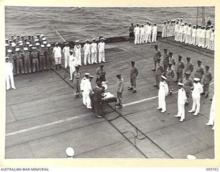 AT SEA OFF RABAUL, NEW BRITAIN. 1945-09-06. THE SURRENDER CEREMONY ON BOARD THE AIRCRAFT CARRIER HMS GLORY, SHOWING GENERAL H. IMAMURA, COMMANDER EIGHTH AREA ARMY, SIGNING THE INSTRUMENT OF ..