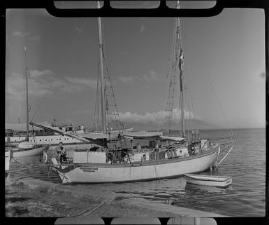 Papeete waterfront, Tahiti, showing skipper, boat Tropic Seas and small dinghy