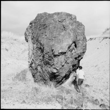 Les Bray standing beside a boulder, Fiji, 1966 / Michael Terry