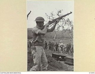 1942-10-29. NEW GUINEA. FUNERAL OF NEW YORK TIMES WAR CORRESPONDENT, BYRON DARNTON. AT THE MILITARY CEMETERY AT PORT MORESBY. SOLDIERS FIRE A VOLLEY. (NEGATIVE BY SILK)