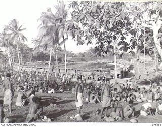 MADANG, NEW GUINEA. 1944-08-15. SOME OF THE 2000 NATIVE LABOURERS WAITING FOR THE ORDER TO EMBUSS ABOARD THE VEHICLES OF THE CONVOY OF SOME 57 VEHICLES FROM THE 165TH GENERAL TRANSPORT COMPANY ..