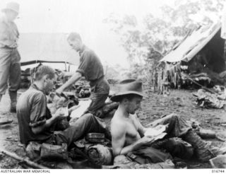 Finisterre Range, New Guinea. 1944-03. An Australian patrol resting after a ten-day patrol towards Japanese held Bogadjim. Private (Pte) S. Nunn of Ipswich, Qld, and Pte K. Noges of Albert Park, ..