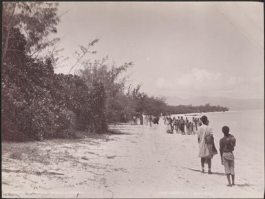 Missionaries and local people on a beach at Rowa, Banks Islands, 1906 / J.W. Beattie
