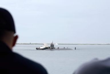 SANTA RITA, Guam (Oct. 19, 2006) Sailors aboard submarine tender USS FRANK CABLE (AS 40) watch as the nuclear-powered attack submarine USS SEAWOLF (SSN 21) moves into position to come alongside ship in Apra Harbor. This is the first time a Seawolf-class vessel has made a port call in Guam. U.S. Navy photo by Mass Communication SPECIALIST 2nd Class Edward N. Vasquez (Released)