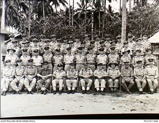 Astrolabe Bay, Madang, New Guinea, 1945-09. Outdoors group portrait of the officers of Headquarters, RAAF Northern Command (NORCOM). The man in the front row (seventh from left) is the unit's ..