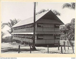 JACQUINOT BAY, NEW BRITAIN. 1945-06-09. THE BUILDING HOUSING AUSTRALIAN ARMY MEDICAL WOMEN'S SERVICE PERSONNEL OF 2/8 GENERAL HOSPITAL IN 5 BASE SUB-AREA. THIS TWO STORIED BUILDING OF TIMBER ..