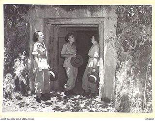 RABAUL, NEW BRITAIN. 1945-11-04. AUSTRALIAN ARMY MEDICAL WOMEN'S SERVICE PERSONNEL FROM 118 GENERAL HOSPITAL LOOKING AT ONE OF THE MANY TUNNELS DUG BY THE JAPANESE INTO THE SURROUNDING HILLSIDES AS ..