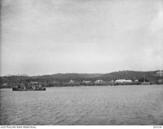 HERBERTSHOHE, NEW BRITAIN, WITH H.M.A.T.B.D. "YARRA". (TAKEN IN 1914-09, FROM H.M.A.S. "ENCOUNTER", AFTER SHELLING THE ROAD 3 MILES INLAND.) (DONATED BY COMMANDER G.F. LANGFORD, R.A.N.)