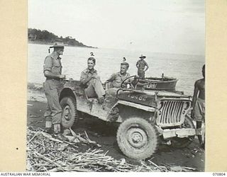 LABU, NEW GUINEA, 1944-03-03. NGX2199 CAPTAIN V.H. SHERWIN, THE CHURCH OF ENGLAND CHAPLAIN (1), GREETING QX34507 LIEUTENANT COLONEL W.J. REINHOLD, CBE, MC, COMMANDER ROYAL ENGINEERS (A.I.F.), (2), ..