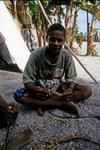 Youth shaves himself a thatching needle