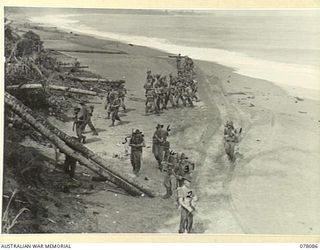 ROCKEY CREEK, NEW GUINEA. 1944-12-31. A PATROL FROM NO.7 PLATOON, A COMPANY, 2/11TH INFANTRY BATTALION DISPERSE BEFORE CLIMBING A HIGH BANK FROM THE BEACH DURING THEIR MOVE FORWARD TO RELIEVE A ..