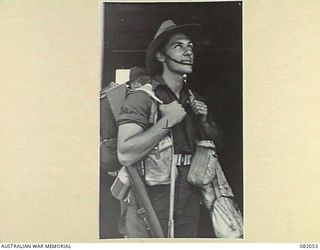 CAIRNS, QLD. 1944-10-28. PRIVATE BENTLEY, C COMPANY, 2/4 INFANTRY BATTALION BOARDING THE USS MEXICO DURING EMBARKATION FOR NEW GUINEA