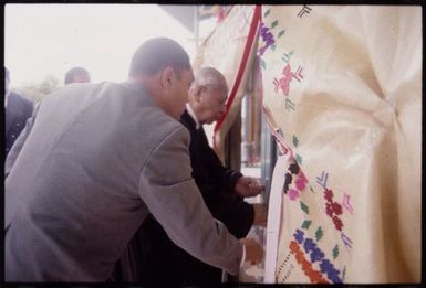 King Taufa'ahau Tupou IV enters the new church, Vaine Moʻonia, through a portal of fine mats