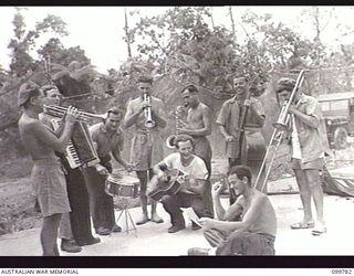 TOROKINA, BOUGAINVILLE, 1945-11-03. THE BAND OF THE KOOKAROOS CONCERT PARTY, AUSTRALIAN ARMY AMENITIES SERVICE, REHEARSING IN PREPARATION FOR THE NIGHT'S SHOW