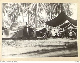 AITAPE, NEW GUINEA. 1944-11-22. A MECHANICAL TRANSPORT STORES VEHICLE, CARRYING SMALL PARTS FOR VEHICLE REPAIRS, (1), POSITIONED ALONGSIDE A MACHINE TRUCK, (2), AT 135 BRIGADE WORKSHOP. THE MACHINE ..