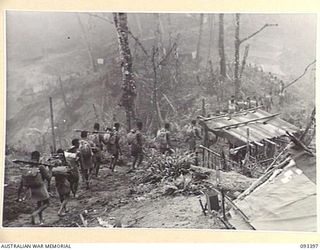 BERRY'S HILL, CENTRAL BOUGAINVILLE, 1945-06-27. TROOPS OF PAPUAN INFANTRY BATTALION IN THE CENTRAL SECTOR, ATTACHED TO 7 INFANTRY BATTALION, SET OUT FROM BERRY'S HILL TO CARRY OUT A HARASSING ROLE ..