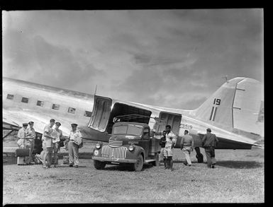 Dakota transport plane and truck, with unidentified army officers and locals, Nausori Airfield, Fiji